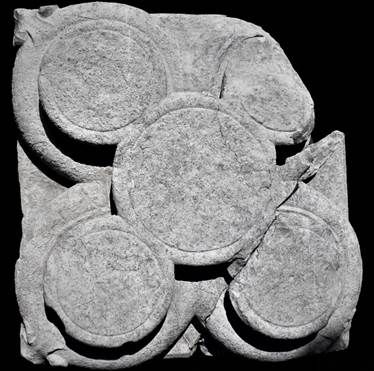 A stone carving of circles 
AI-generated content may be incorrect.